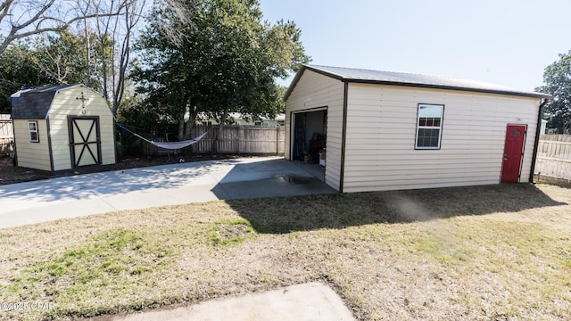 view of outbuilding with fence and an outdoor structure