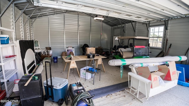 garage featuring metal wall and a garage door opener