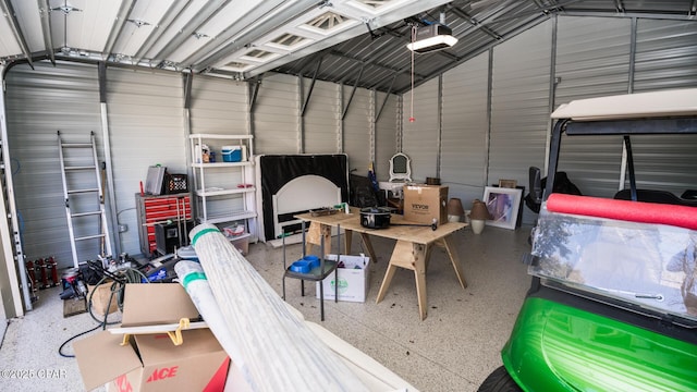 garage with metal wall and a garage door opener