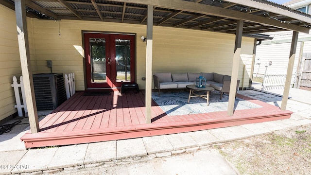 wooden deck with an outdoor hangout area, french doors, and central air condition unit