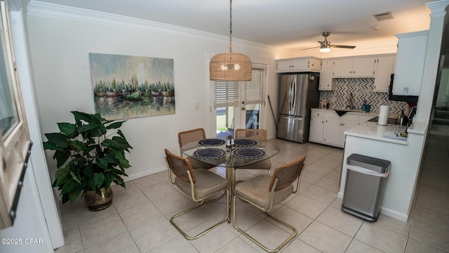 dining area with light tile patterned floors, ornamental molding, and visible vents