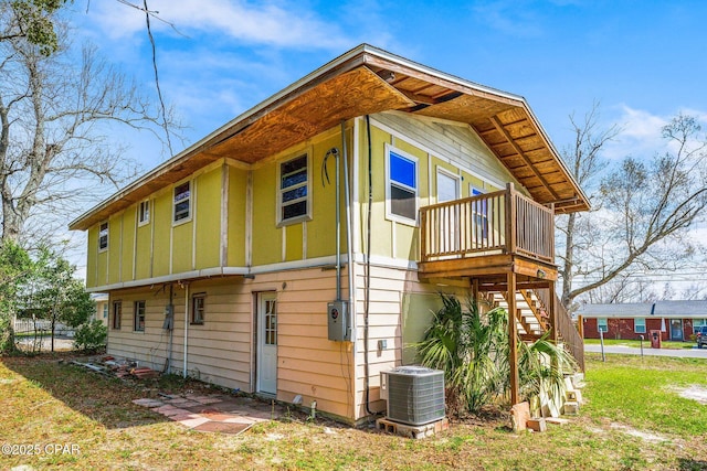 819 Russ Lake Dr, Panama City, FL 32404 - view of side of home with central air condition unit, board and batten siding, and stairway
