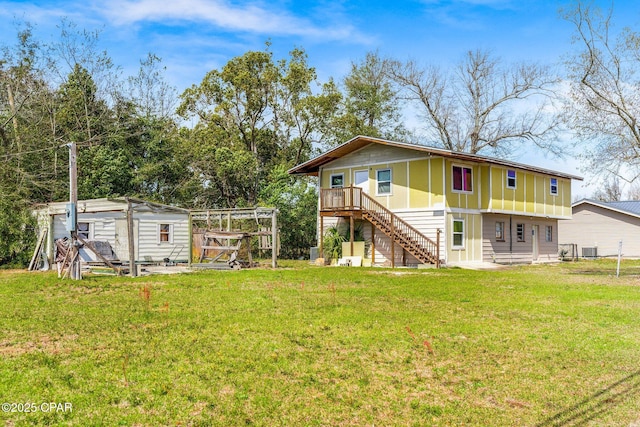 819 Russ Lake Dr, Panama City, FL 32404 - back of house with a lawn, stairs, central AC, and an outdoor structure