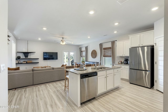 358 Sea Grove Way, Port St Joe, FL 32456 - kitchen featuring stainless steel appliances, a ceiling fan, white cabinets, light stone countertops, and recessed lighting