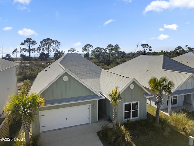 358 Sea Grove Way, Port St Joe, FL 32456 - view of front of home featuring board and batten siding, an attached garage, roof with shingles, and driveway