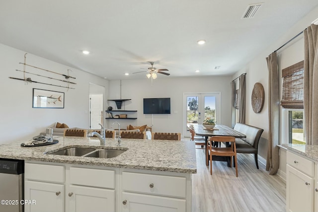 358 Sea Grove Way, Port St Joe, FL 32456 - kitchen featuring stainless steel dishwasher, open floor plan, ceiling fan, light stone counters, and light wood-style floors
