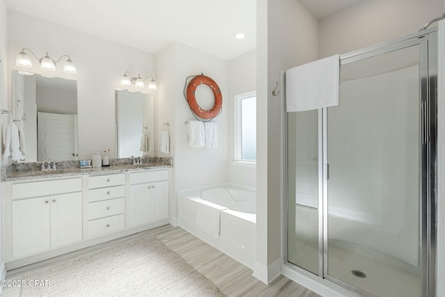 358 Sea Grove Way, Port St Joe, FL 32456 - full bath featuring a garden tub, double vanity, wood finished floors, and a shower stall