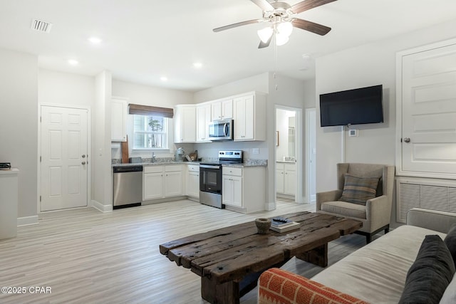 358 Sea Grove Way, Port St Joe, FL 32456 - living area with light wood-type flooring, ceiling fan, and recessed lighting
