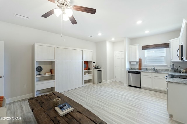 358 Sea Grove Way, Port St Joe, FL 32456 - kitchen with stainless steel appliances, light wood-type flooring, light stone counters, recessed lighting, and white cabinetry