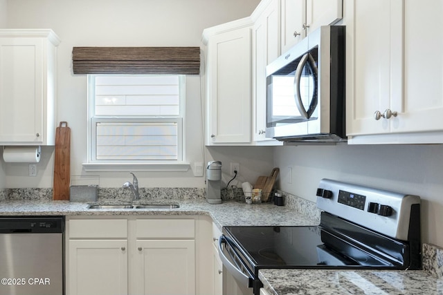 358 Sea Grove Way, Port St Joe, FL 32456 - kitchen featuring stainless steel appliances, white cabinetry, and light stone counters