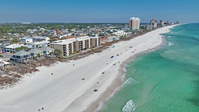 aerial view with a city view, a water view, and a beach view