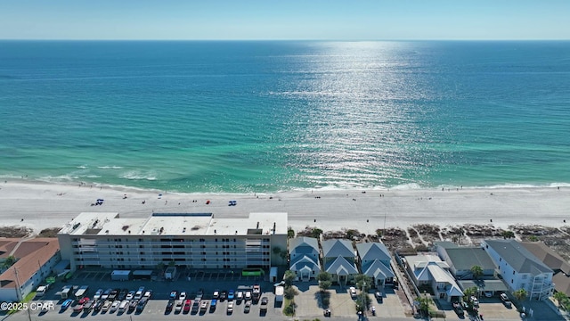 bird's eye view with a water view and a view of the beach