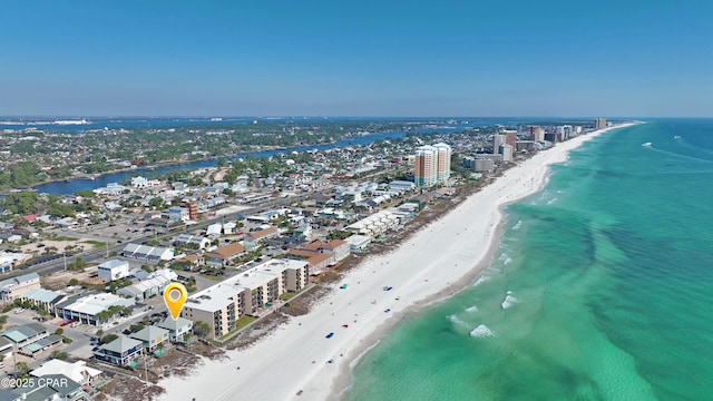 drone / aerial view featuring a view of the beach, a water view, and a city view