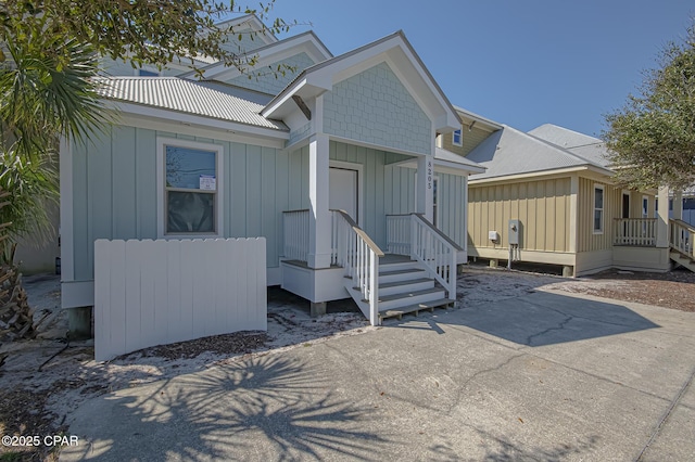 manufactured / mobile home featuring metal roof and board and batten siding