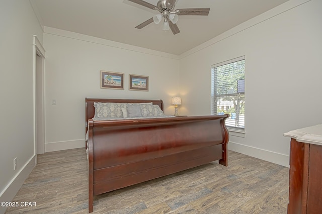 bedroom featuring baseboards, ceiling fan, wood finished floors, and crown molding