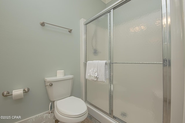 full bathroom with a shower stall and toilet