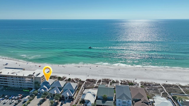 drone / aerial view featuring a beach view and a water view