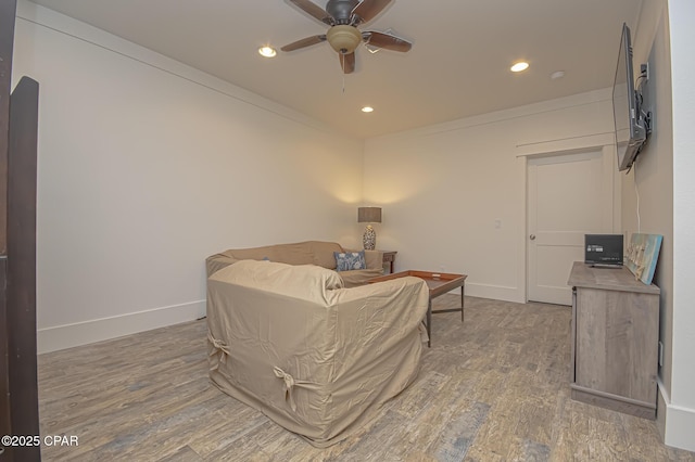 living area with recessed lighting, baseboards, and wood finished floors