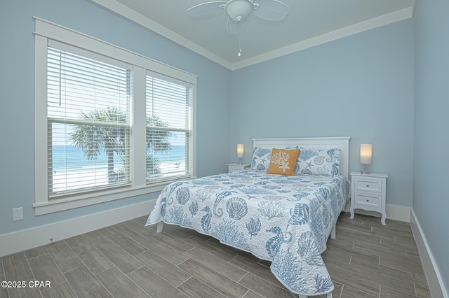 bedroom with crown molding, ceiling fan, baseboards, and wood tiled floor