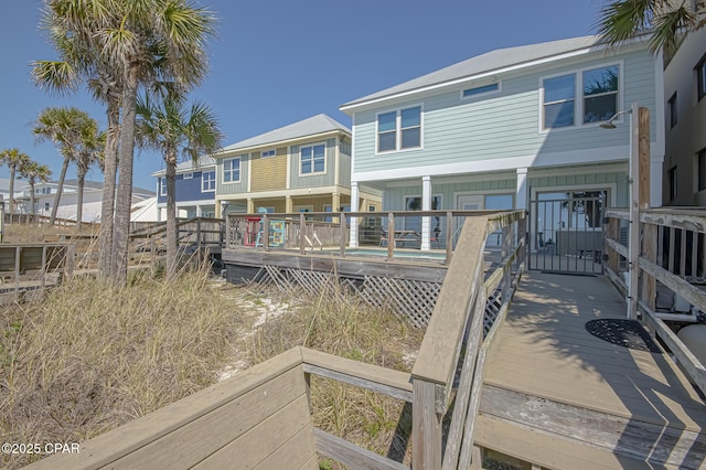 rear view of house featuring covered porch