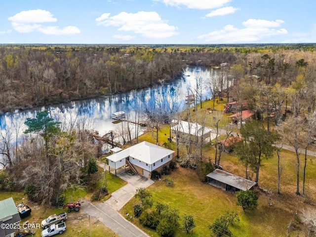 drone / aerial view with a water view and a wooded view