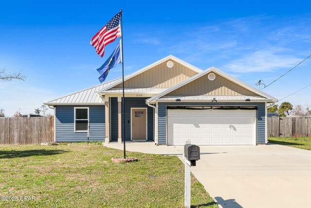 single story home featuring a garage, fence, driveway, and a front lawn