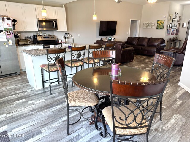 dining space with light wood-type flooring