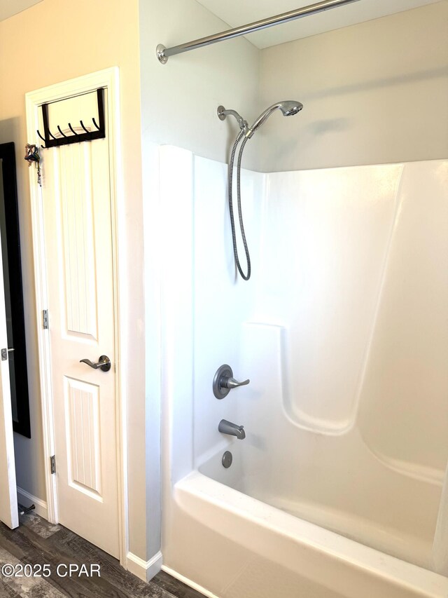 full bathroom featuring shower / washtub combination and wood finished floors