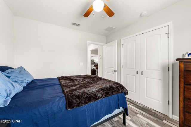 bedroom featuring a ceiling fan, light wood-type flooring, a closet, and visible vents