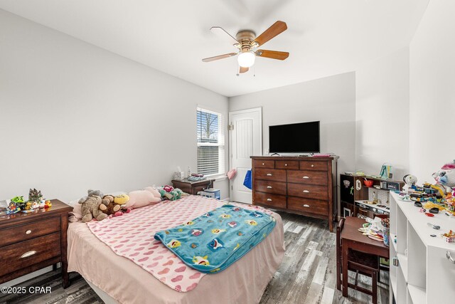 bedroom with wood finished floors and a ceiling fan