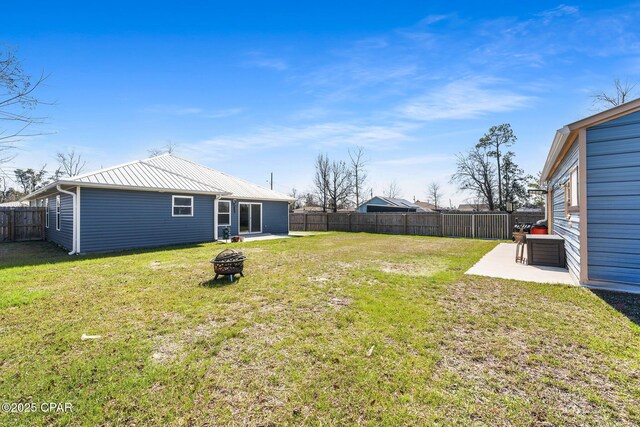 view of yard featuring a patio, an outdoor fire pit, and a fenced backyard