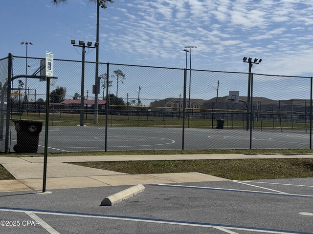 view of basketball court with community basketball court and fence