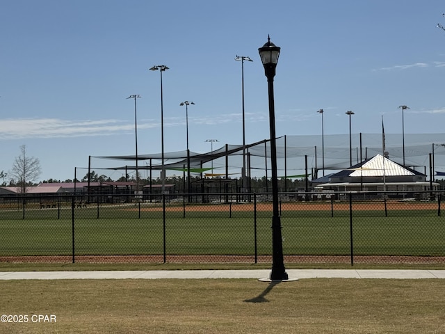 view of tennis court featuring fence