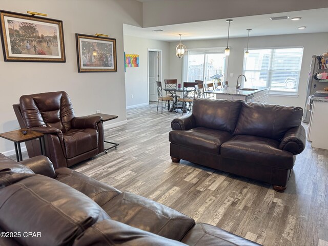 living area with baseboards and light wood-style floors