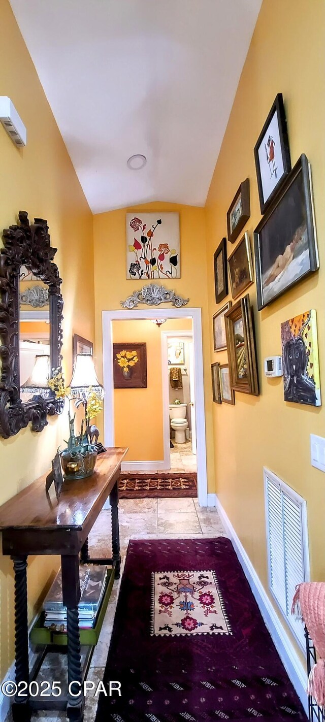 205 Harmon Ave, Panama City, FL 32401 - corridor with baseboards, light tile patterned flooring, and high vaulted ceiling