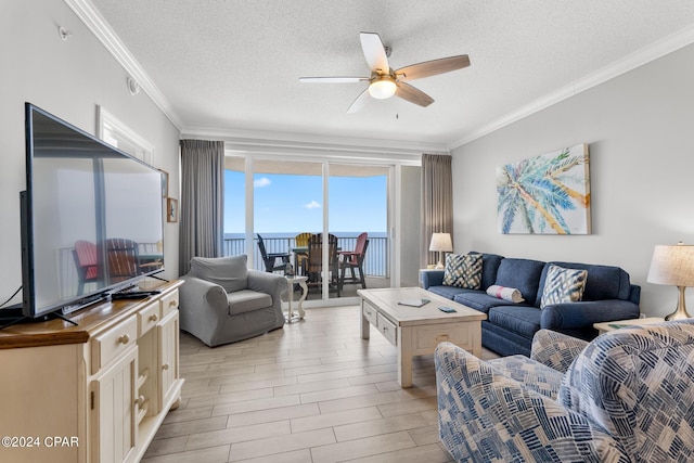 living room featuring wood finish floors, a textured ceiling, a ceiling fan, and ornamental molding