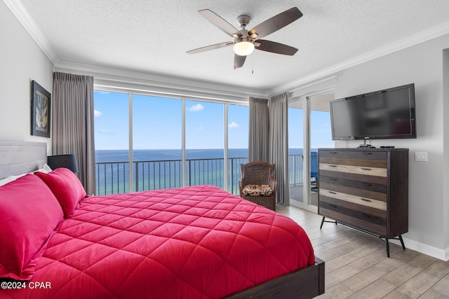 bedroom featuring a textured ceiling, a ceiling fan, light wood-style floors, access to outside, and crown molding