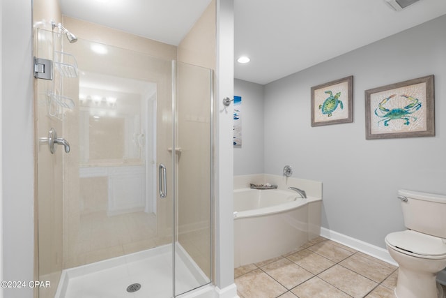 bathroom featuring tile patterned floors, a garden tub, toilet, and a stall shower