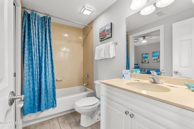 bathroom featuring visible vents, toilet, wood finished floors, shower / bath combination with curtain, and vanity