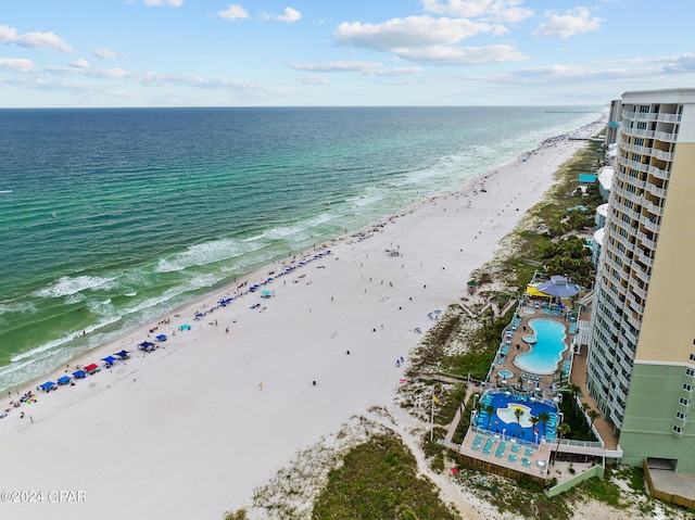 birds eye view of property featuring a beach view and a water view