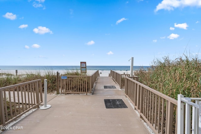 surrounding community featuring a view of the beach and a water view