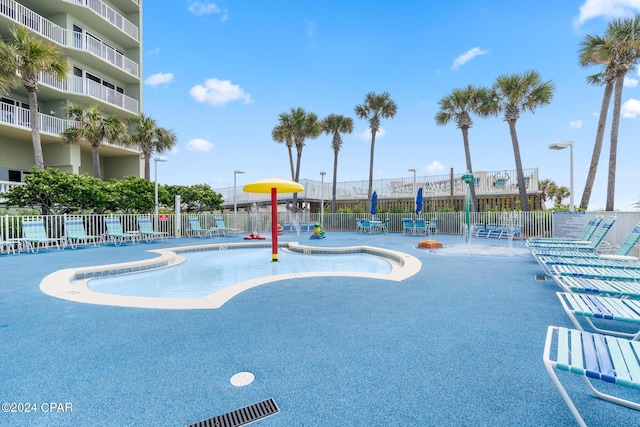 surrounding community with fence and a pool