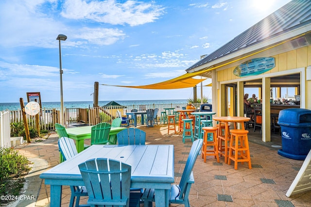 view of patio featuring outdoor dining area and a water view