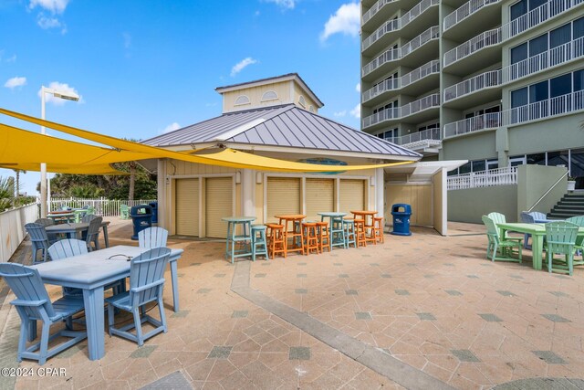 view of patio featuring grilling area, outdoor dining area, and fence