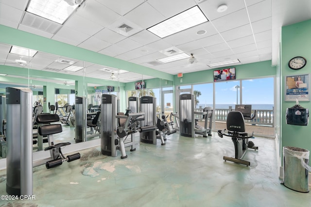 gym with a paneled ceiling and visible vents