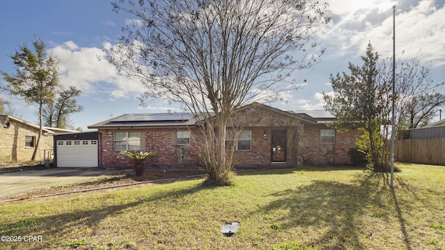 single story home with fence, a garage, concrete driveway, solar panels, and a front lawn