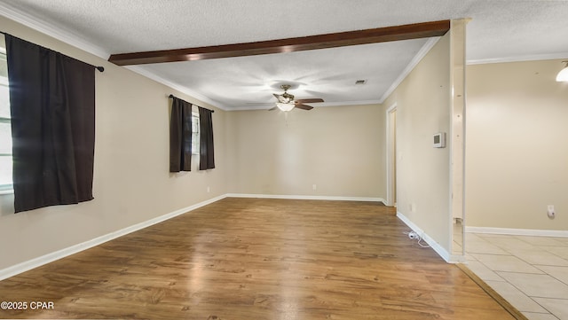 spare room featuring crown molding, wood finished floors, ceiling fan, and a textured ceiling