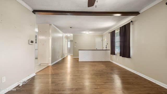 interior space featuring wood finished floors, ceiling fan, and a textured ceiling