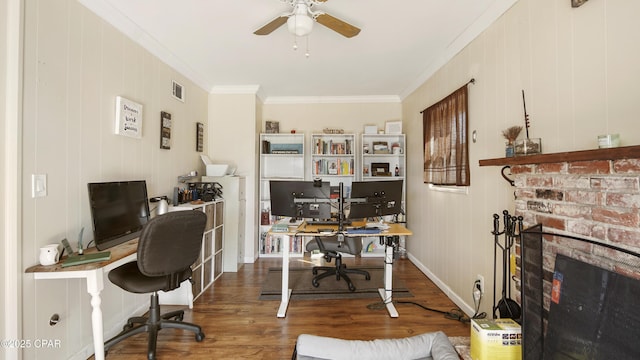 office featuring ceiling fan, wood finished floors, visible vents, baseboards, and ornamental molding