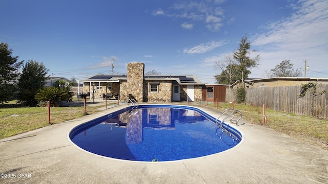 view of pool featuring a fenced in pool, fence, and a patio area